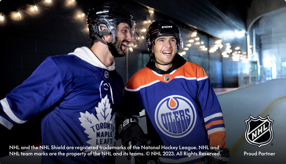 Two friends smile while wearing hockey jerseys
