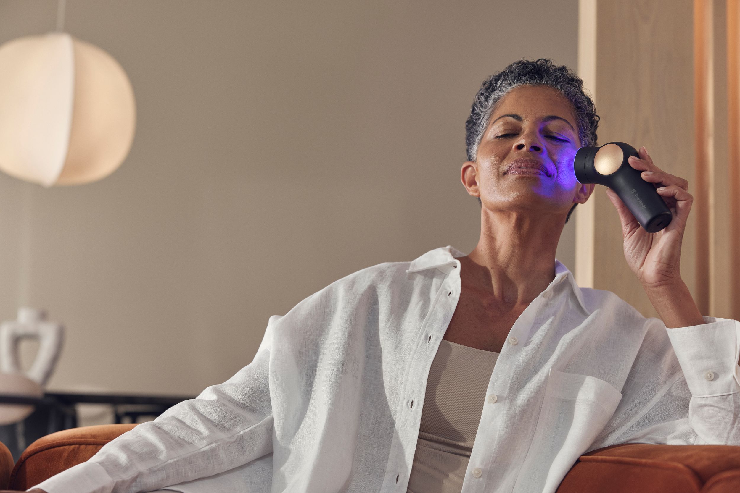 Therabody Theraface Pro Massage Device Back_Angled_Left